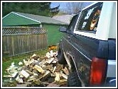 1993 Ford Bronco - Firewood stacked next to the rear of a 1993 Ford Bronco.
