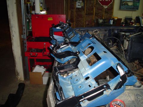 1984 Ford Bronco - Interior parts are piled up inside a vehicle, suggesting a rebuild or repair process.