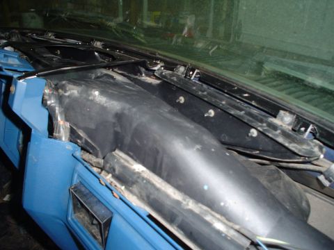 1984 Ford Bronco - The dashboard and windshield area of a blue vehicle is shown with parts removed for repair or modification.