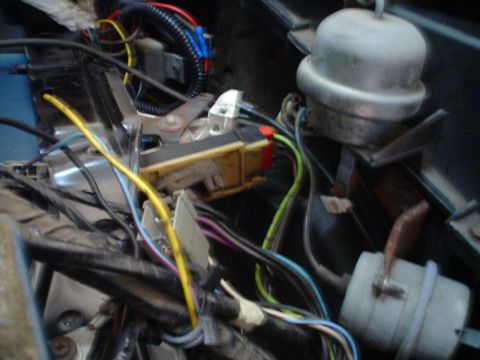 1984 Ford Bronco - A complex network of wires and electrical components are visible in this close-up shot of a vehicle's interior wiring.