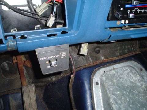 1984 Ford Bronco - Interior view of a 1984 Ford Bronco, focusing on the rear defrost switch and dashboard wiring.