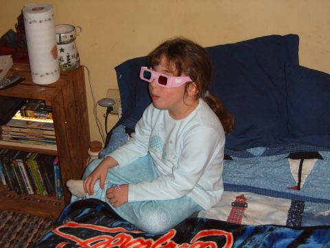 1993 Ford Bronco - A young girl sits on a bed wearing pink 3D glasses, looking off to the side.