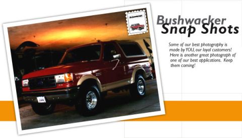 1991 Ford Bronco - A red Ford Bronco is shown in a garage with warm lighting on the ceiling.