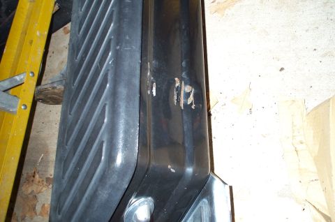 1978 Dodge Power Ram - This image shows a close-up of a truck's fender and running board, with a yellow ladder in the background.