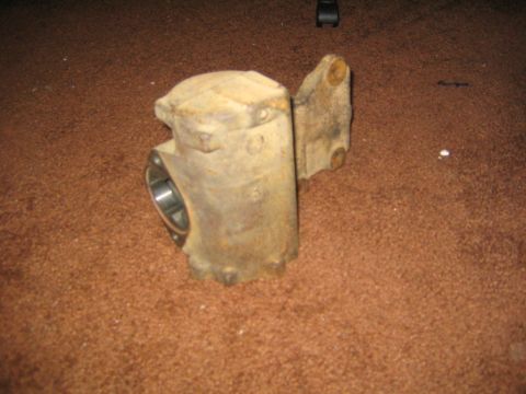 1978 Ford Bronco - A used steering box component rests on a carpeted surface, showing signs of age and wear.