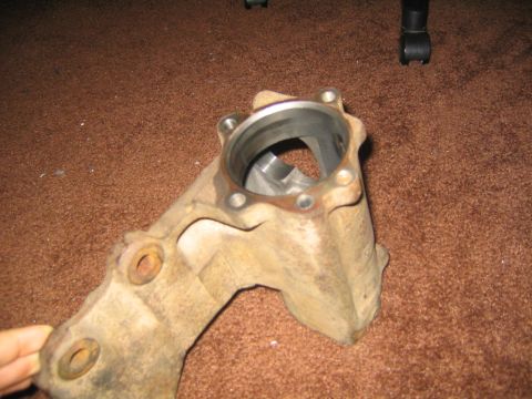 1978 Ford Bronco - A close-up view of a steering box component, likely from a vehicle, resting on a carpeted surface.