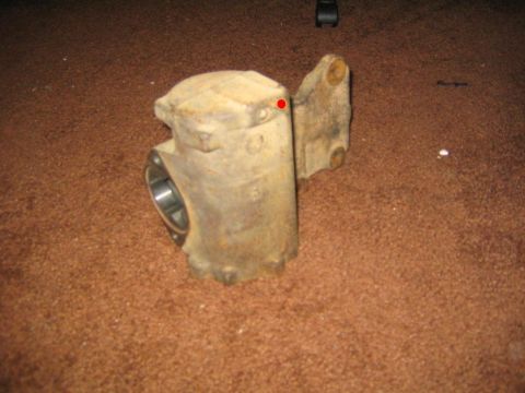 1978 Ford Bronco - A worn steering box, likely a vehicle part, is shown against a carpeted background.