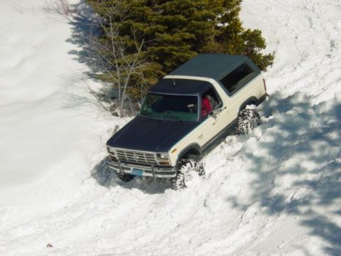1986 Ford Bronco - This Ford Bronco navigates a snowy slope, its off-road capabilities.