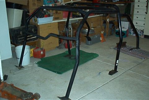 1986 Ford Bronco - Roll cage assembly shown in a garage setting, possibly for a Ford Bronco.