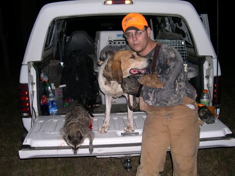 1992 Ford Bronco - Hunter with his dog and a raccoon in the back of a pickup truck.