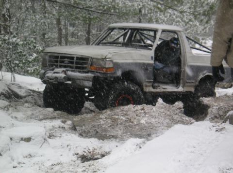 1995 Ford Bronco - This modified 1995 Ford Bronco navigates a snowy, muddy trail with its doors open.