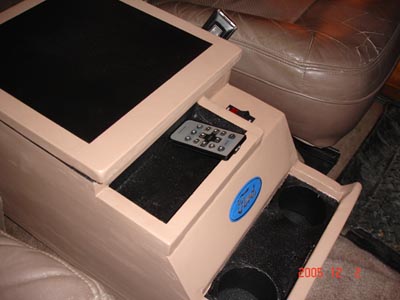 1995 Ford Bronco - Custom center console with a remote control and a blue emblem is installed in a vehicle's interior.