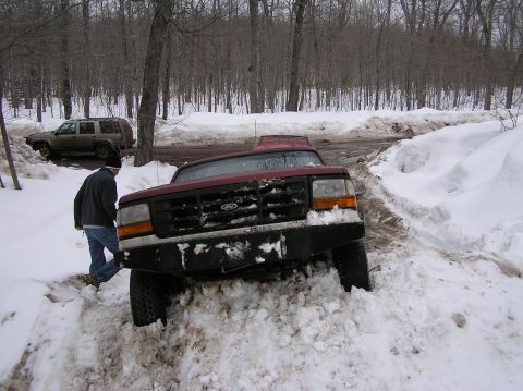 2000 Chevrolet Tahoe - Ford F-Series truck stuck in snow with another vehicle in the background.