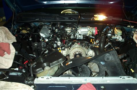 1998 Ford Crown Victoria - The engine bay of a 1998 Ford Crown Victoria is shown with various components and wiring.