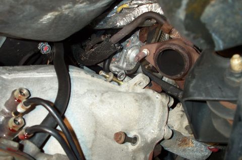 1998 Ford Crown Victoria - This image shows a close-up view of various engine components, including hoses and exhaust parts.
