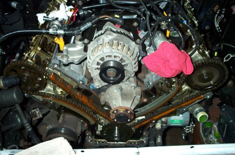 1998 Ford Crown Victoria - Engine timing chain and alternator assembly, with Supermotors.net branding visible.