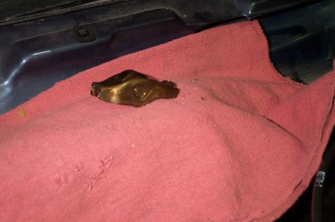 1998 Ford Crown Victoria - A single engine rocker arm is shown on a red cloth, likely during a repair or maintenance procedure.