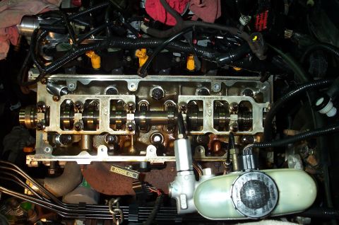 1998 Ford Crown Victoria - Close-up view of internal engine components, including camshafts and fuel injectors, during a repair.