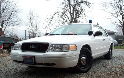 1998 Ford Crown Victoria - This police car appears to be a Ford Crown Victoria, but the model year is likely later than 1998.