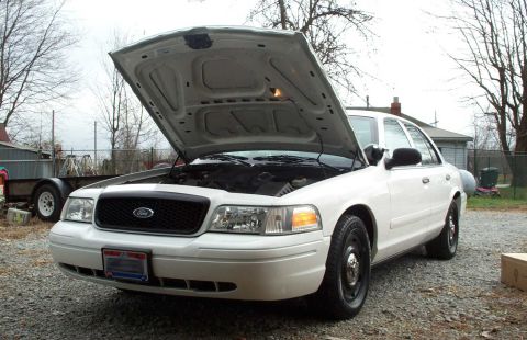 1998 Ford Crown Victoria - This 1998 Ford Crown Victoria is shown with its hood open, revealing the engine compartment.