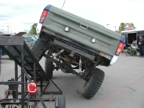 1977 Ford F-150 - This 1977 Ford F-150 is being loaded onto a trailer ramp, showing its rear end and lifted suspension.