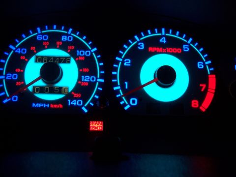 1995 Ford Probe - Dashboard gauges with blue illumination, showing 50 MPH and 0-8 RPM.