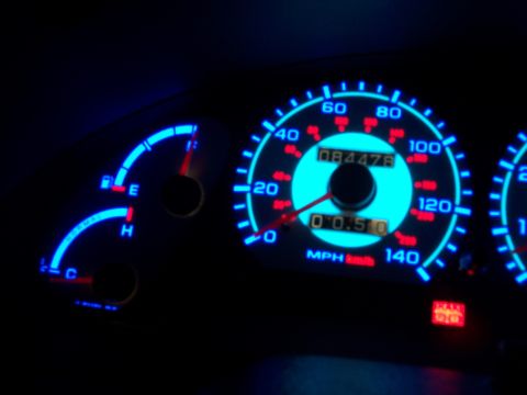 1995 Ford Probe - Close-up of illuminated dashboard gauges, showing speed and mileage.
