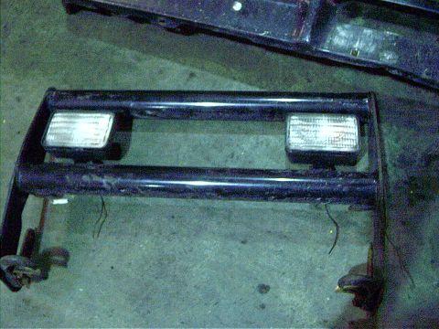 1979 Ford Bronco - A black bull bar with integrated fog lights is shown, likely a vehicle accessory.