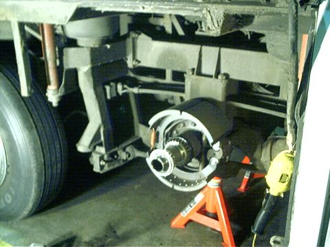 1979 Ford Bronco - Close-up view of a vehicle's undercarriage, focusing on the brake system and suspension components.