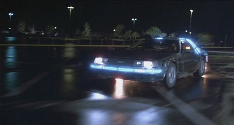 1978 Ford Bronco - A DeLorean DMC-12 is seen driving at night with its signature blue lights illuminated.