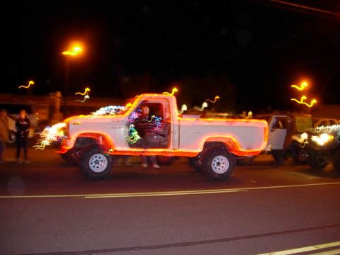1981 Ford F-150 - A 1981 Ford F-150 pickup truck is seen decorated with festive lights during a nighttime event.