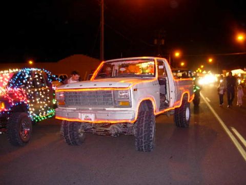 1981 Ford F-150 - A Ford F-Series truck decorated with lights for a parade or event at night.