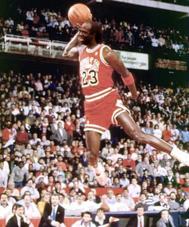 1991 Ford Bronco - Michael Jordan, number 23, soars through the air for a dunk during a basketball game.
