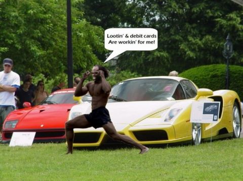 1991 Ford Bronco - A man poses in front of two sports cars, one yellow and one red, with a speech bubble above him.