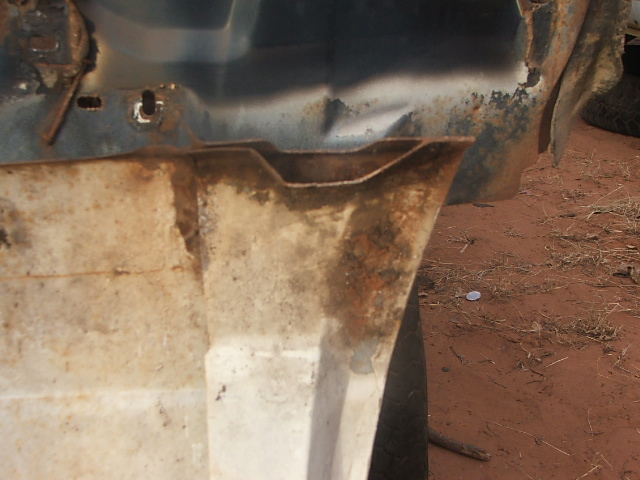 Rusted metal panel with visible Supermotors.net watermark