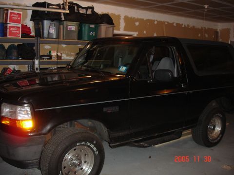 2004 Suzuki GSX-R 1000 - A black Ford Bronco is parked in a garage, showing its side profile and front fender.