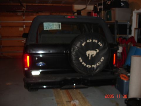 2004 Suzuki GSX-R 1000 - Rear view of a black Ford Bronco parked indoors with a spare tire cover.