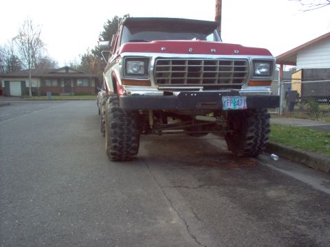 1992 Ford Bronco - This lifted Ford truck has a prominent grille and large off-road tires, suggesting an older model year.