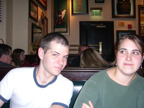 1996 Ford Probe - Two people are seated in a booth at a restaurant, with various framed items visible on the wall behind them.