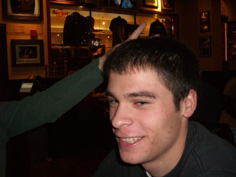 1996 Ford Probe - A person's arm is playfully placed on a man's head inside a Hard Rock Cafe.