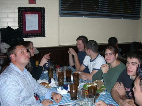 1996 Ford Probe - A group of friends enjoys a meal together at a table in a dimly lit restaurant.