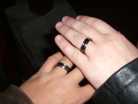 1996 Ford Probe - Two hands, each adorned with a black ring silver stripes, are gently crossed.