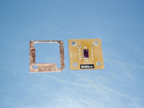 1989 Ford Bronco - A computer processor and its accompanying metal bracket are displayed against a plain blue surface.