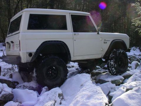 1969 Ford Bronco - White 1969 Ford Bronco tackling a snowy, rocky trail.