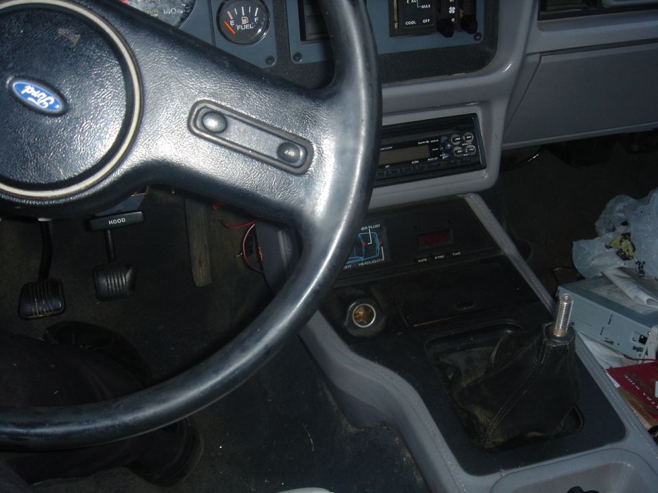 Ford steering wheel, dashboard, and center console with a stick shift