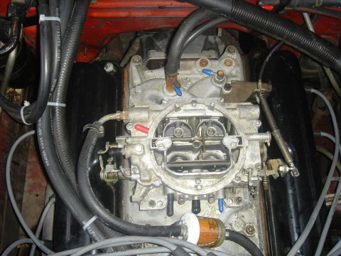1986 Ford Mustang - Engine bay detail showing a carburetor and associated fuel and electrical lines.