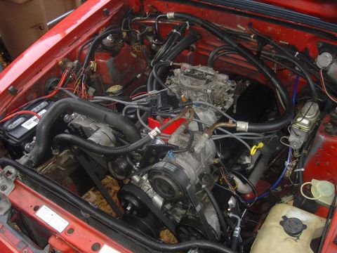 1986 Ford Mustang - Close-up view of a car's engine compartment, showing various components and wiring.