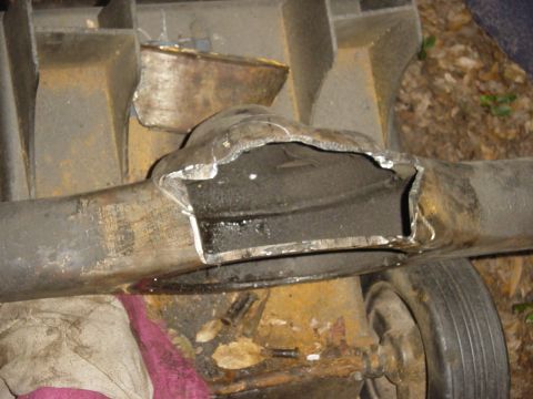 1989 Ford Bronco - Close-up of a heavily modified rear axle housing, revealing internal components after a section has been cut away.
