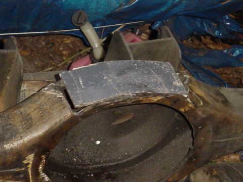 1989 Ford Bronco - A close-up view of a vehicle part, possibly a fender or body panel, covered by a blue tarp.