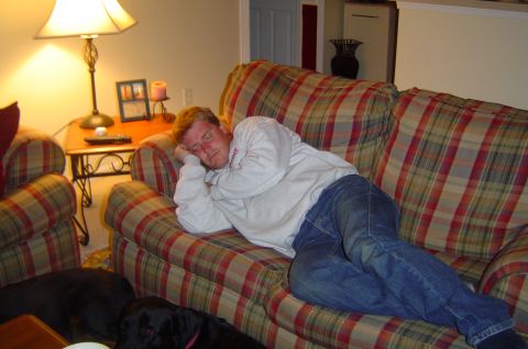 1993 Ford Bronco - Man asleep on a couch with two dogs resting on the floor.